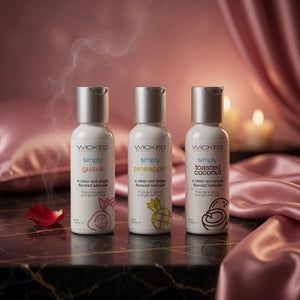 Three Wicked Sensual Care products on a marble surface with a soft, warm background.