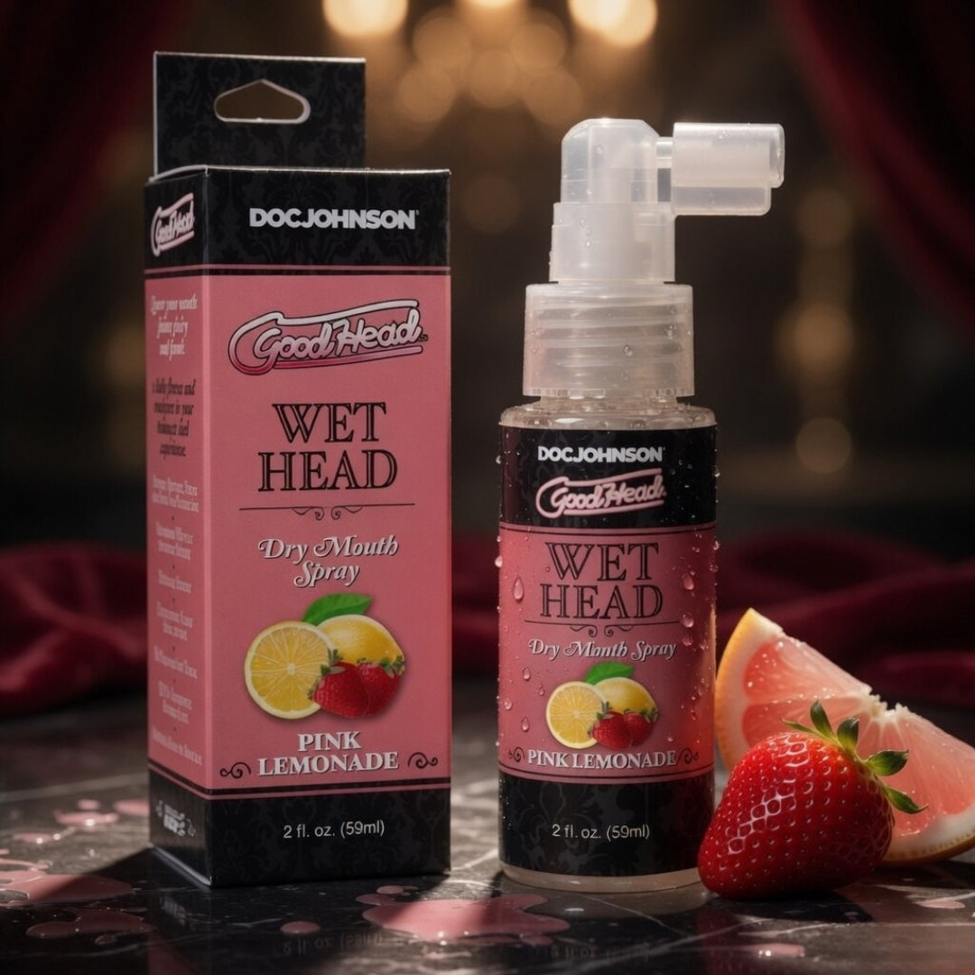 Doc Johnson GoodHead Wet Head Dry Mouth Spray packaging and bottle on a dark background with fruit slices.