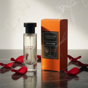 Perfume bottle and packaging with red rose petals on a reflective surface