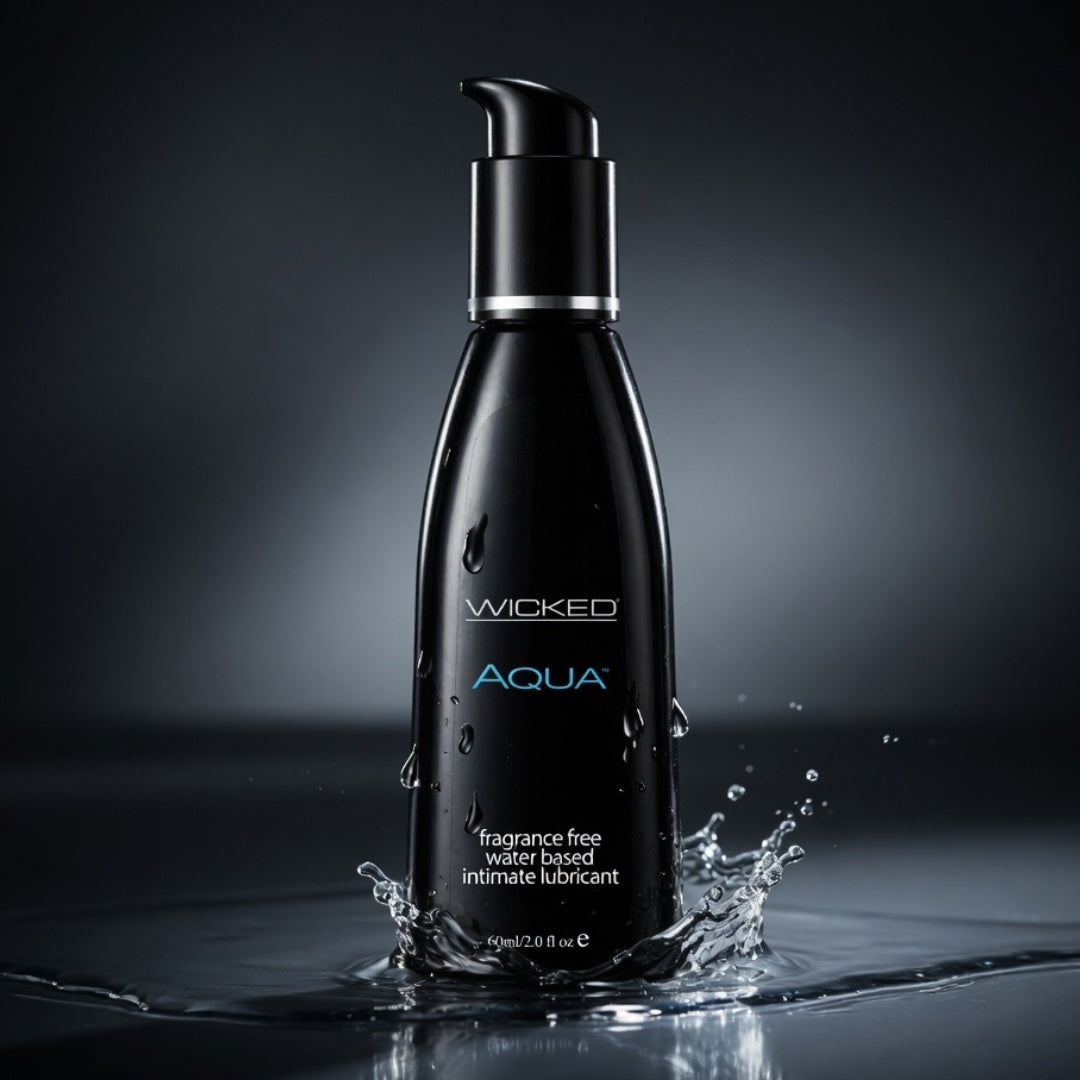 Black bottle of Wicked Aqua lubricant with water splashing around it on a dark background